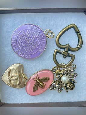Louis Vuitton Lavender Charm, Chanel button, and Gucci bag charm. Vintage